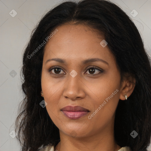 Joyful black young-adult female with long  brown hair and brown eyes