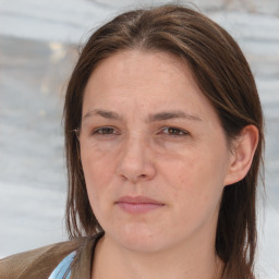 Joyful white adult female with long  brown hair and brown eyes