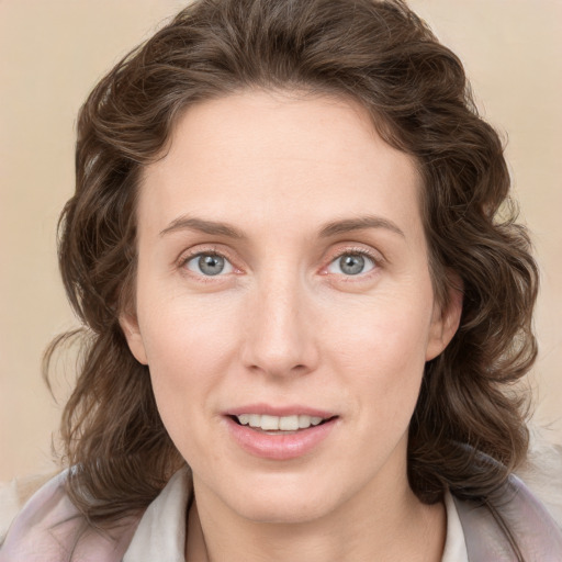 Joyful white young-adult female with medium  brown hair and blue eyes