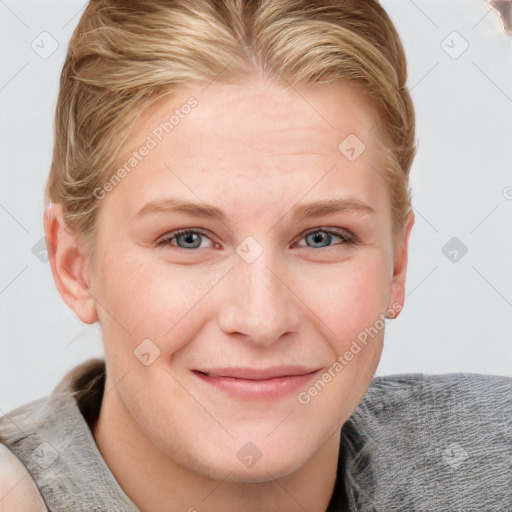 Joyful white young-adult female with short  brown hair and blue eyes