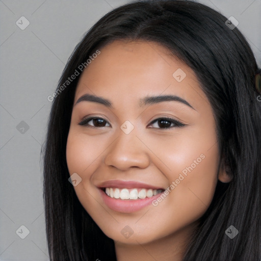 Joyful latino young-adult female with long  black hair and brown eyes