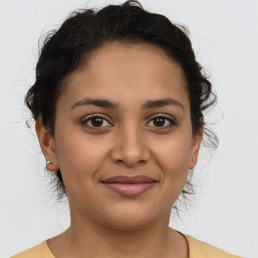 Joyful latino young-adult female with short  brown hair and brown eyes