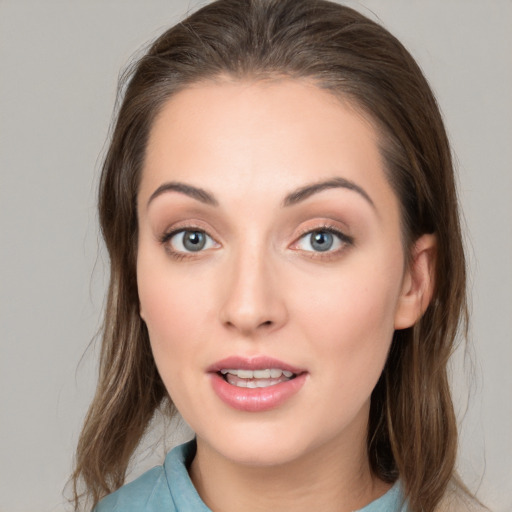 Joyful white young-adult female with medium  brown hair and grey eyes