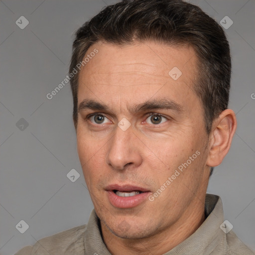 Joyful white adult male with short  brown hair and brown eyes