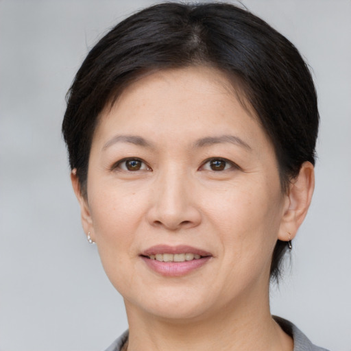 Joyful white adult female with short  brown hair and brown eyes