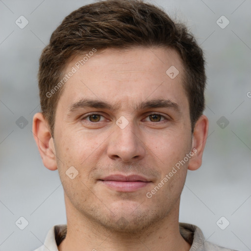 Joyful white young-adult male with short  brown hair and grey eyes