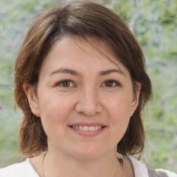 Joyful white adult female with medium  brown hair and brown eyes