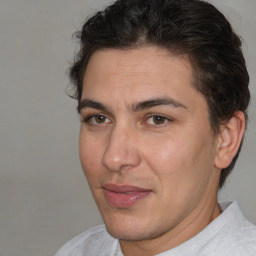 Joyful white adult male with short  brown hair and brown eyes