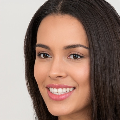 Joyful white young-adult female with long  black hair and brown eyes