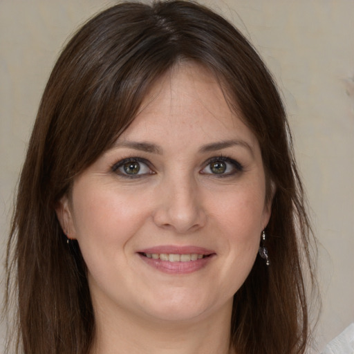 Joyful white young-adult female with medium  brown hair and green eyes