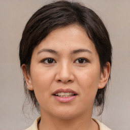 Joyful asian young-adult female with medium  brown hair and brown eyes