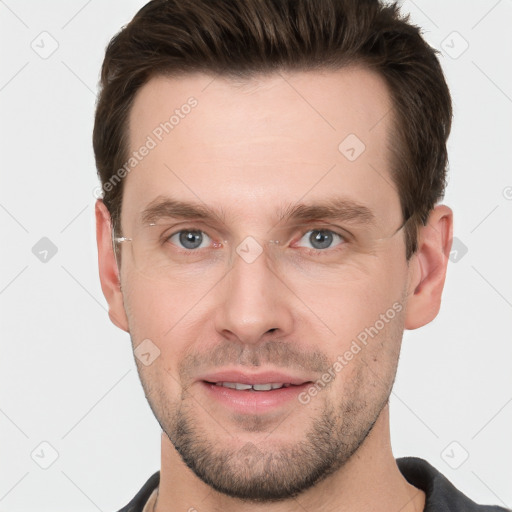 Joyful white young-adult male with short  brown hair and grey eyes