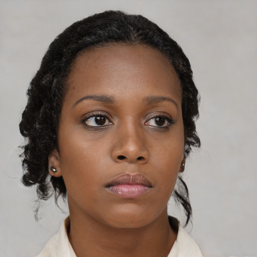 Neutral black young-adult female with medium  brown hair and brown eyes