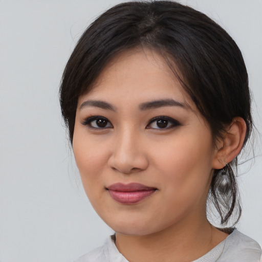 Joyful asian young-adult female with medium  black hair and brown eyes