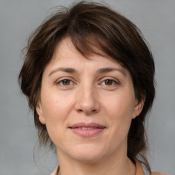 Joyful white adult female with medium  brown hair and brown eyes