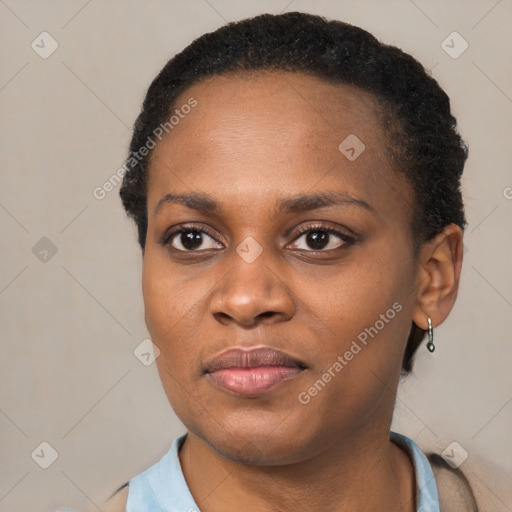 Joyful black young-adult female with short  black hair and brown eyes