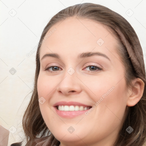 Joyful white young-adult female with long  brown hair and blue eyes