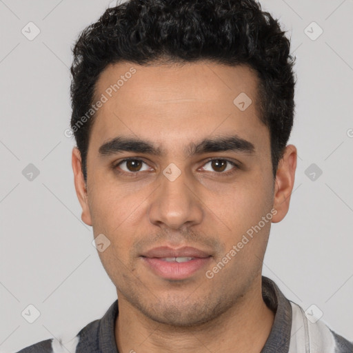 Joyful white young-adult male with short  black hair and brown eyes