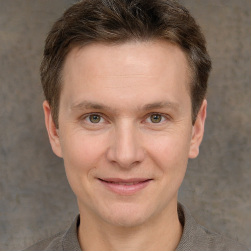 Joyful white adult male with short  brown hair and grey eyes