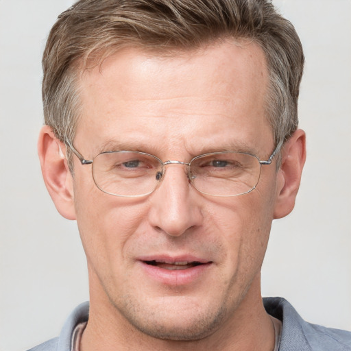 Joyful white adult male with short  brown hair and grey eyes