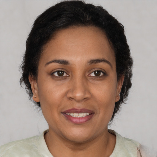 Joyful latino adult female with short  brown hair and brown eyes