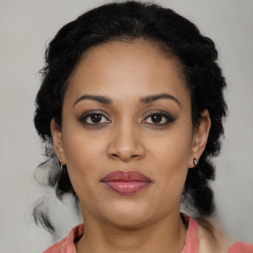 Joyful black young-adult female with medium  black hair and brown eyes