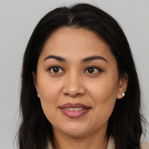 Joyful asian adult female with long  brown hair and brown eyes