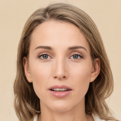 Joyful white young-adult female with medium  brown hair and grey eyes