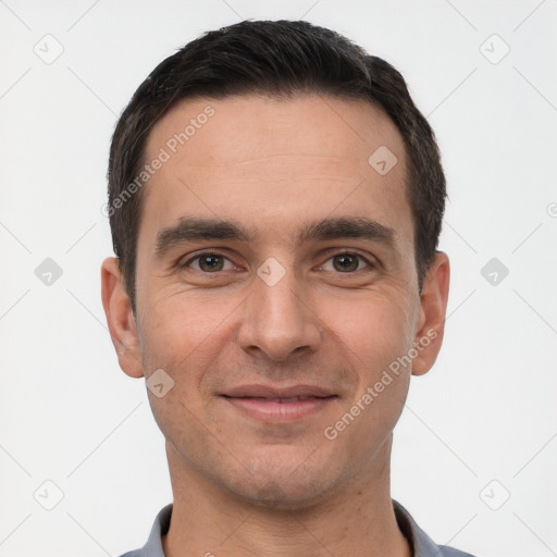 Joyful white young-adult male with short  black hair and brown eyes