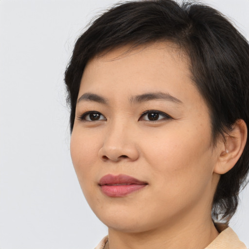 Joyful asian young-adult female with medium  brown hair and brown eyes