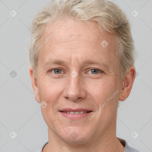 Joyful white middle-aged male with short  brown hair and grey eyes