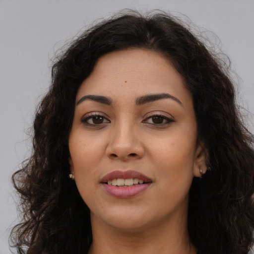Joyful latino young-adult female with long  brown hair and brown eyes