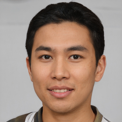 Joyful asian young-adult male with short  brown hair and brown eyes