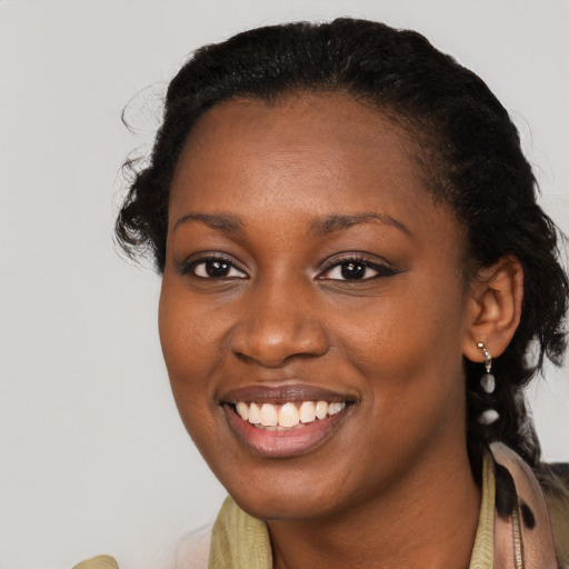 Joyful black young-adult female with medium  black hair and brown eyes