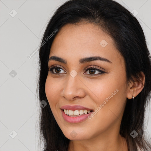 Joyful latino young-adult female with long  brown hair and brown eyes