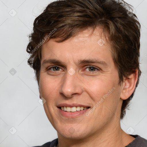 Joyful white young-adult male with medium  brown hair and brown eyes