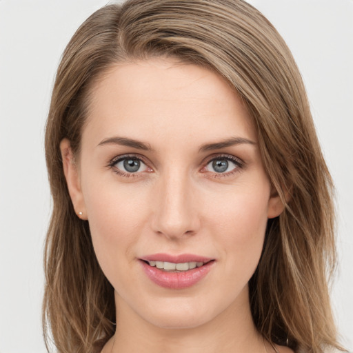 Joyful white young-adult female with long  brown hair and grey eyes