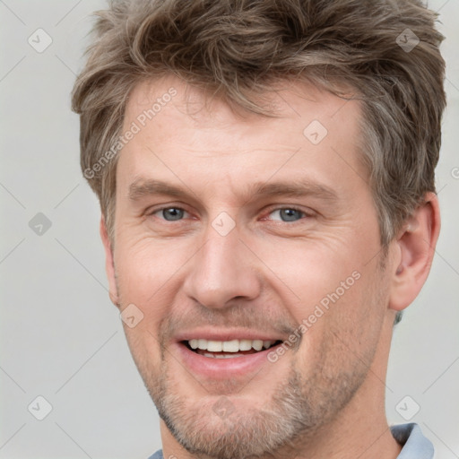 Joyful white adult male with short  brown hair and grey eyes