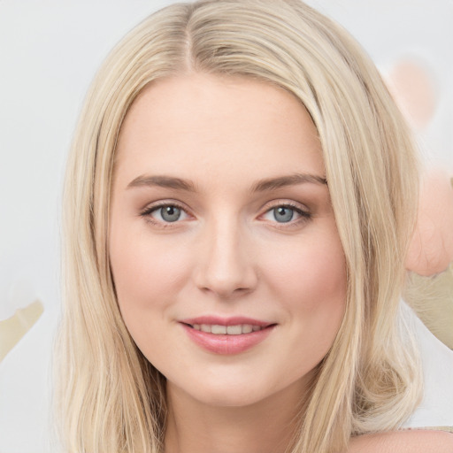 Joyful white young-adult female with long  brown hair and blue eyes