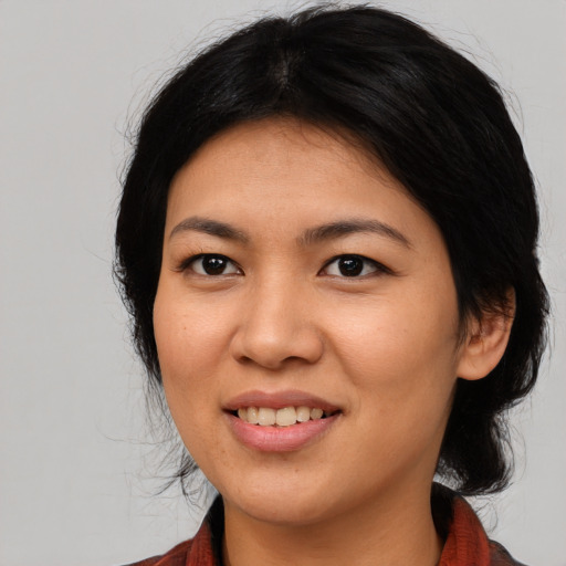 Joyful asian young-adult female with medium  black hair and brown eyes