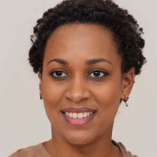 Joyful black young-adult female with short  black hair and brown eyes