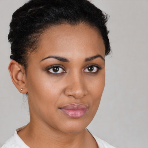 Joyful latino young-adult female with short  brown hair and brown eyes