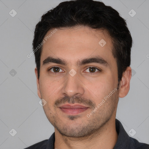 Joyful white young-adult male with short  black hair and brown eyes