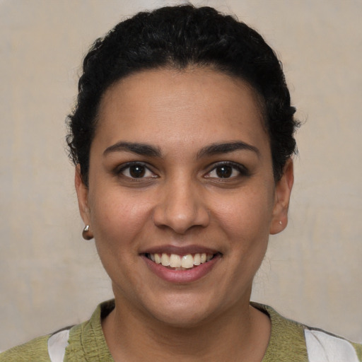 Joyful latino young-adult female with short  brown hair and brown eyes