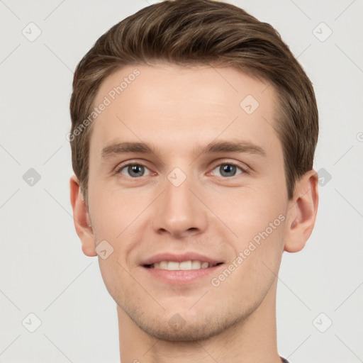 Joyful white young-adult male with short  brown hair and grey eyes