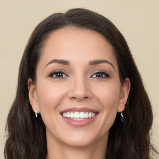 Joyful white young-adult female with long  brown hair and brown eyes