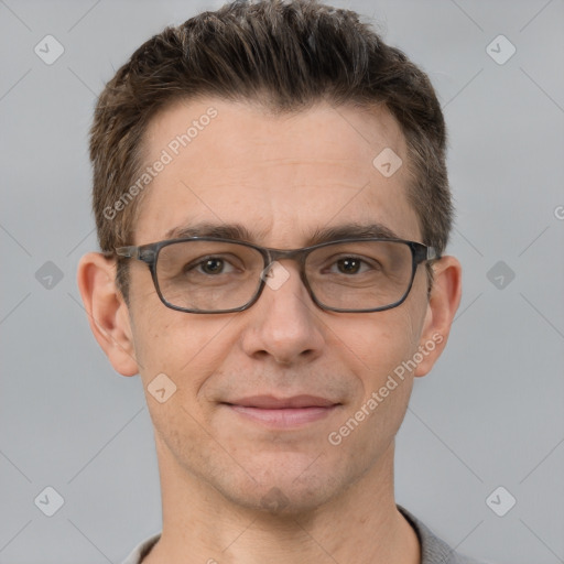 Joyful white adult male with short  brown hair and grey eyes