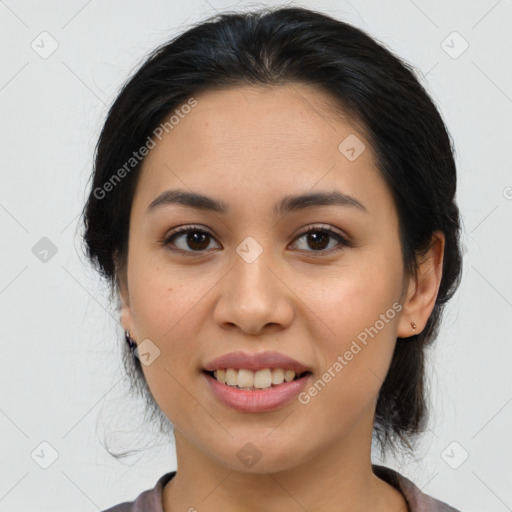 Joyful latino young-adult female with medium  brown hair and brown eyes