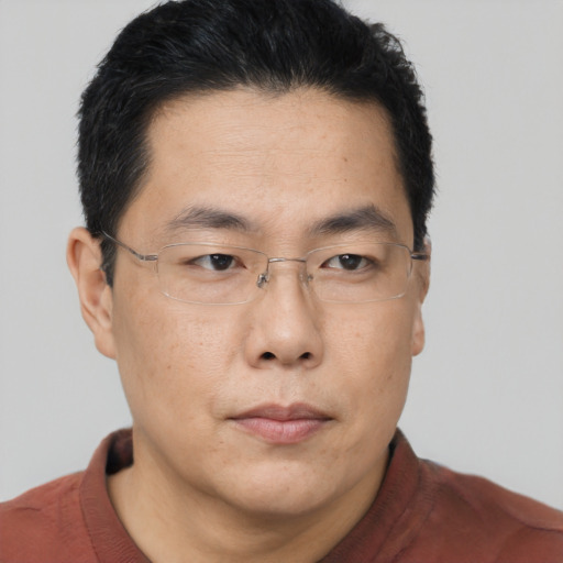 Neutral asian adult male with short  brown hair and brown eyes