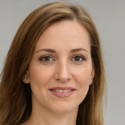 Joyful white young-adult female with long  brown hair and green eyes